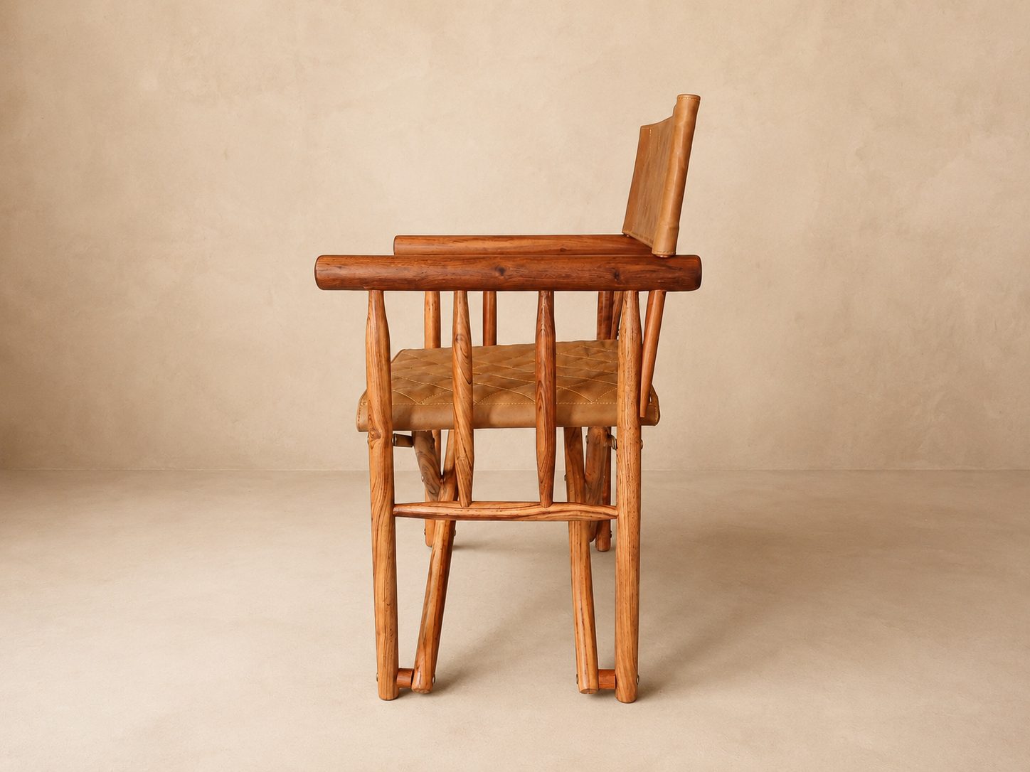 The Kruger Luxury Safari Director's Chair Side View A side view of The Kruger Luxury Safari Director's Chair made from Zambezi Teak with quilted leather seat cover